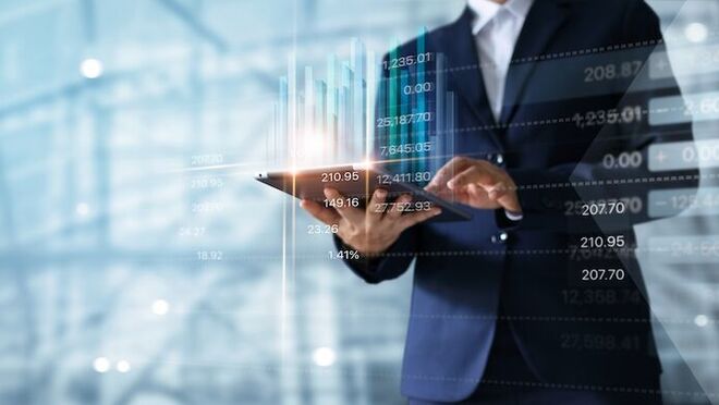 Businessman,Using,Tablet,Analyzing,Sales,Data,And,Economic,Growth,Graph