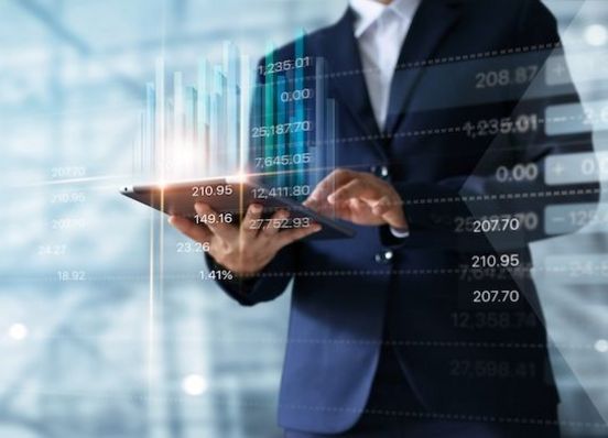 Businessman,Using,Tablet,Analyzing,Sales,Data,And,Economic,Growth,Graph